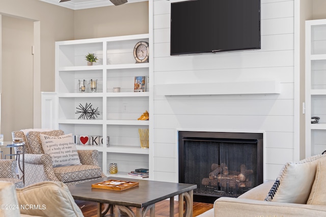 living room with crown molding and hardwood / wood-style floors