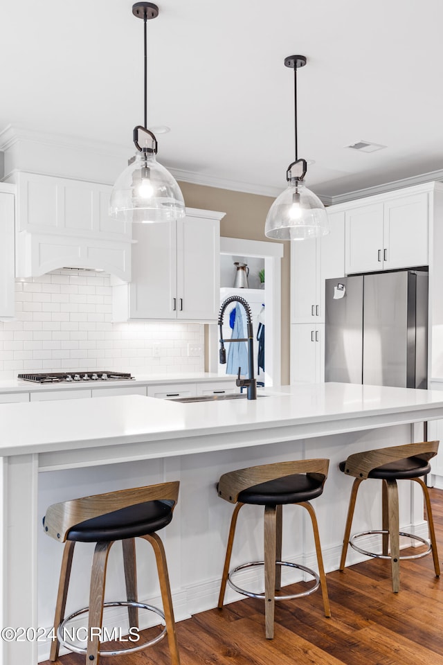 kitchen with white cabinetry, gas stovetop, dark hardwood / wood-style floors, pendant lighting, and custom exhaust hood