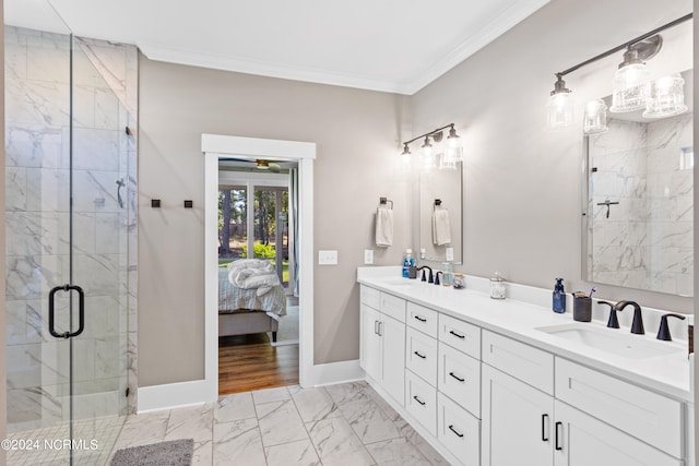 bathroom featuring a shower with door, vanity, and ornamental molding