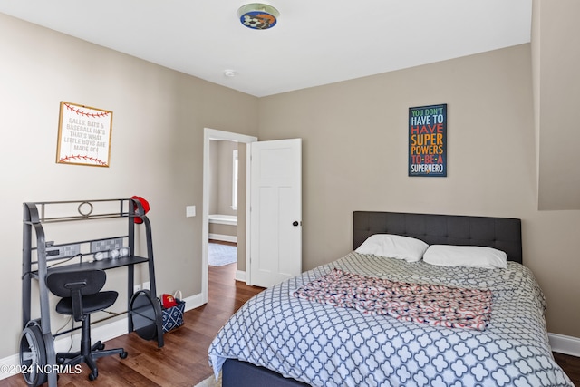 bedroom with dark wood-type flooring