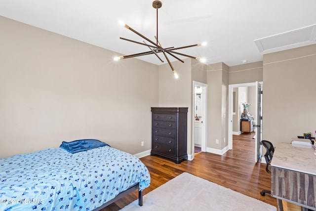 bedroom featuring dark wood-type flooring and a notable chandelier