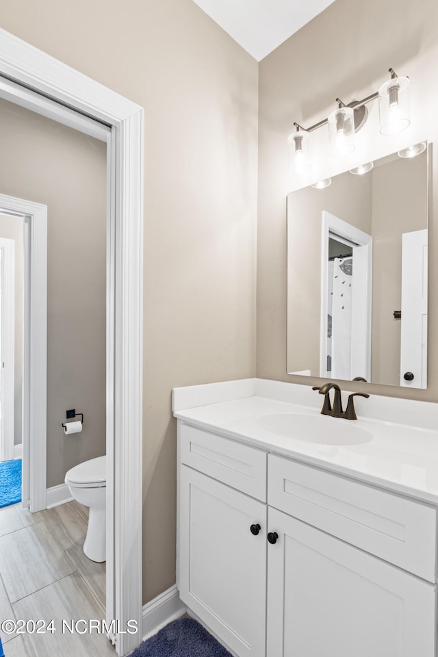 bathroom featuring vanity and toilet