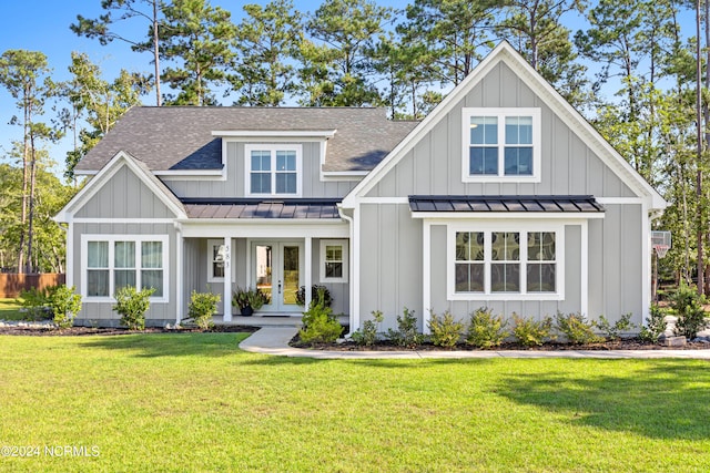 view of front of house featuring a front yard and french doors