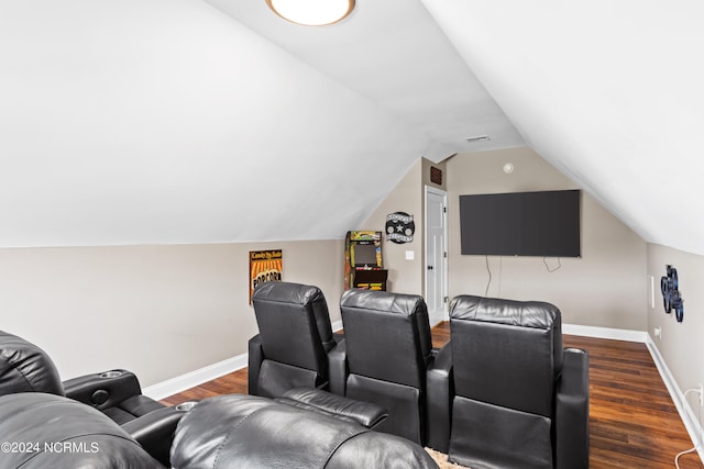 cinema with dark hardwood / wood-style flooring and lofted ceiling