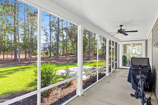 unfurnished sunroom with ceiling fan