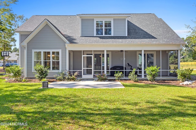 rear view of house featuring a lawn and a sunroom