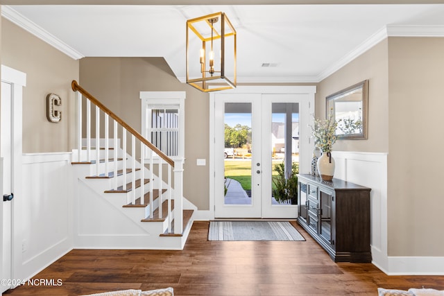 foyer featuring a chandelier, french doors, dark hardwood / wood-style flooring, and ornamental molding