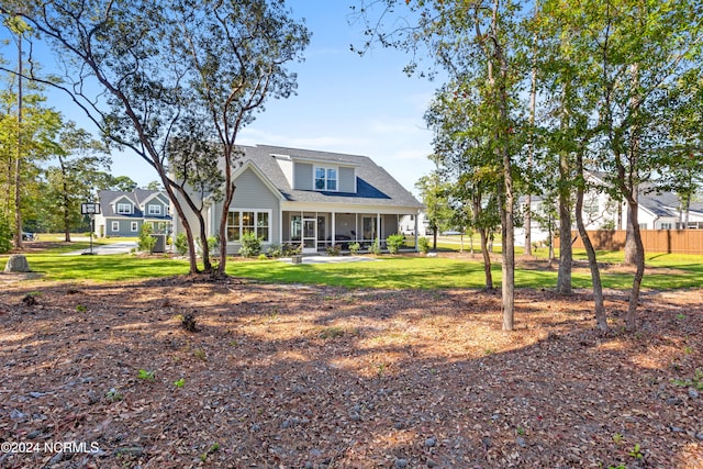 view of front of home featuring a sunroom and a front yard