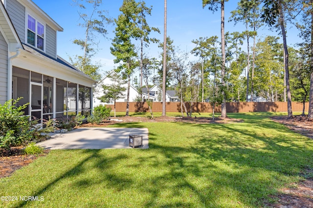 view of yard featuring a patio and a sunroom