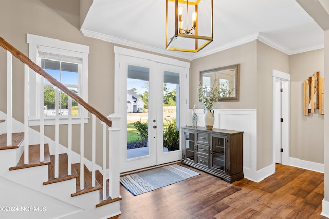 foyer entrance with hardwood / wood-style flooring, plenty of natural light, and french doors