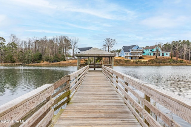 view of dock with a gazebo and a water view