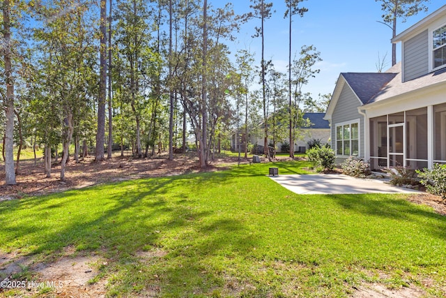 view of yard featuring a patio and a sunroom