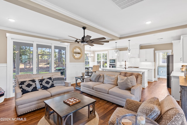 living room featuring a healthy amount of sunlight and ornamental molding