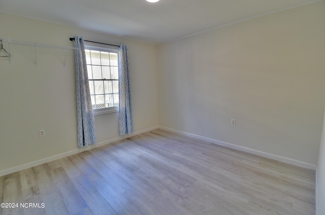 empty room with light hardwood / wood-style flooring