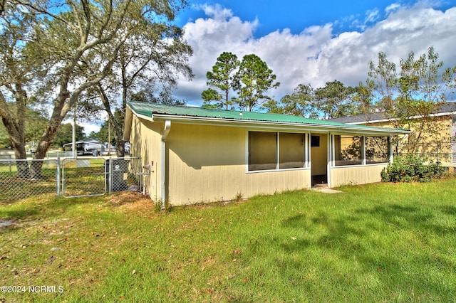 rear view of property with a lawn