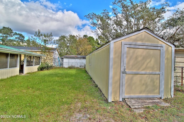 view of outbuilding featuring a yard