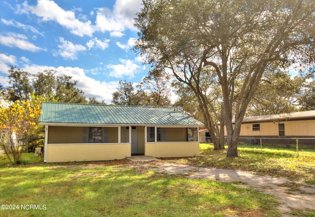 back of property featuring a yard