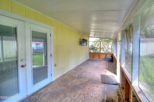 unfurnished sunroom featuring lofted ceiling