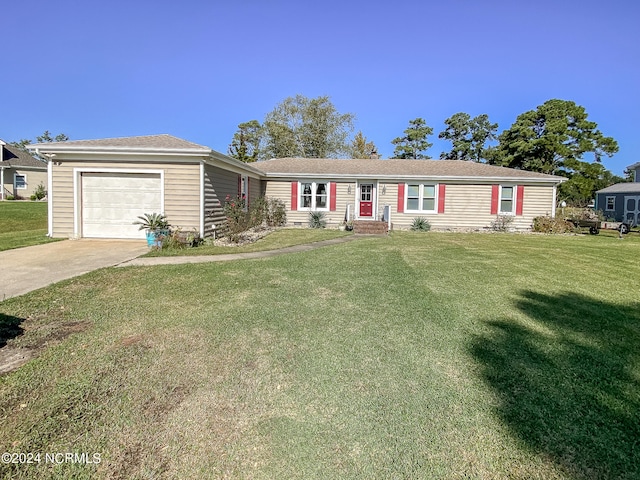 single story home featuring a garage and a front lawn