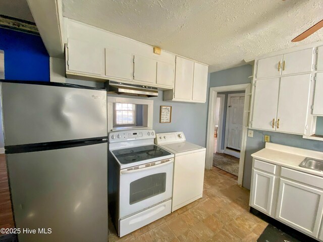 kitchen with washer / dryer, white range with electric stovetop, white cabinetry, and freestanding refrigerator