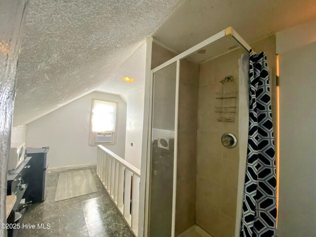 bathroom with a stall shower, cooling unit, lofted ceiling, and a textured ceiling