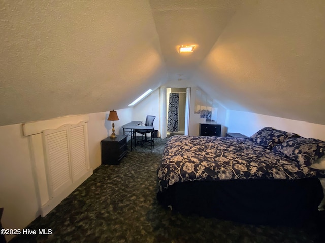 bedroom featuring lofted ceiling, carpet floors, and a textured ceiling