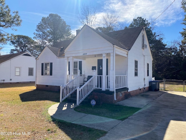 bungalow-style house featuring a shingled roof, crawl space, covered porch, a gate, and a front lawn