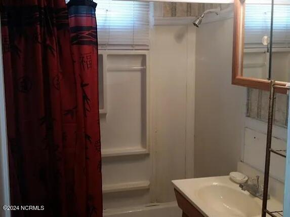 bathroom featuring vanity and walk in shower