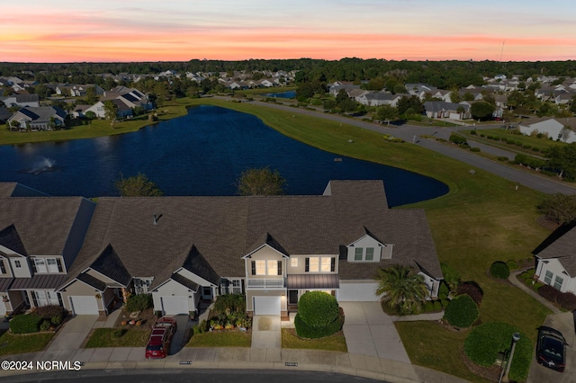 aerial view at dusk with a water view