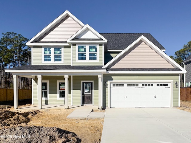 view of front of house featuring covered porch and a garage