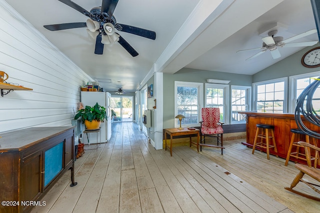 sunroom / solarium featuring lofted ceiling and bar area