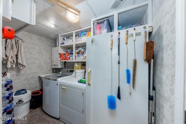 laundry room with washer and dryer and tankless water heater