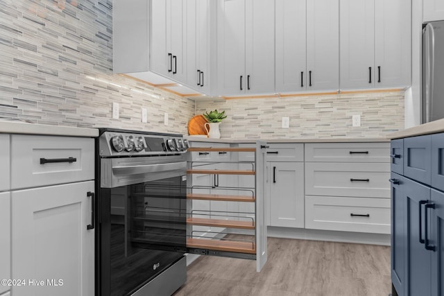 kitchen featuring backsplash, white cabinetry, and light hardwood / wood-style flooring