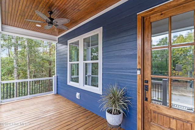 wooden terrace featuring ceiling fan and a porch