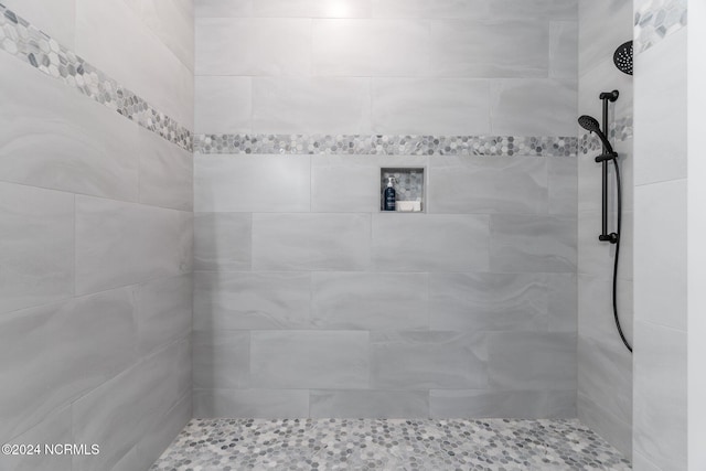 bathroom with tiled shower