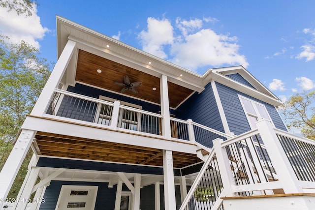 rear view of property featuring ceiling fan