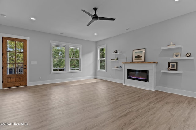 unfurnished living room with ceiling fan and light hardwood / wood-style flooring