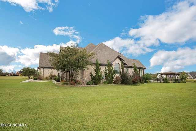 view of property exterior with a gazebo and a yard