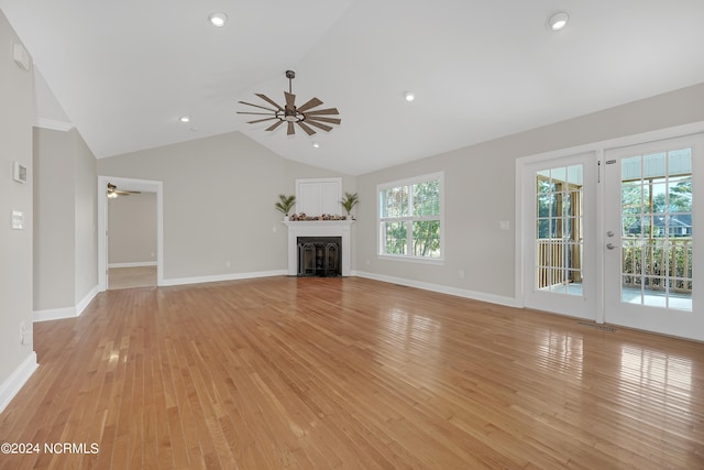 unfurnished living room with lofted ceiling and light hardwood / wood-style flooring