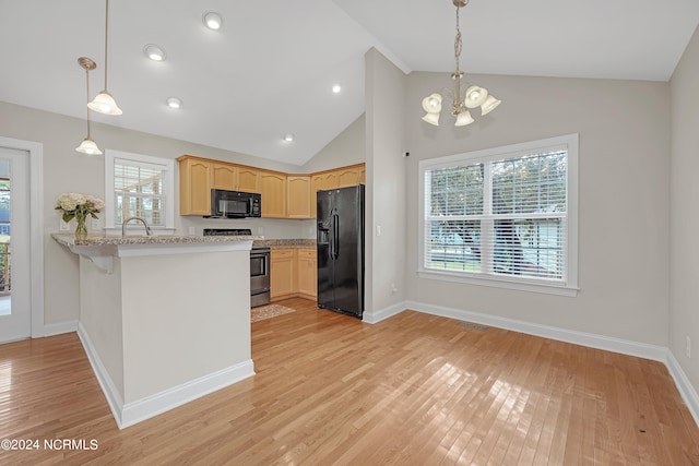 kitchen with hanging light fixtures, black appliances, kitchen peninsula, and light wood-type flooring