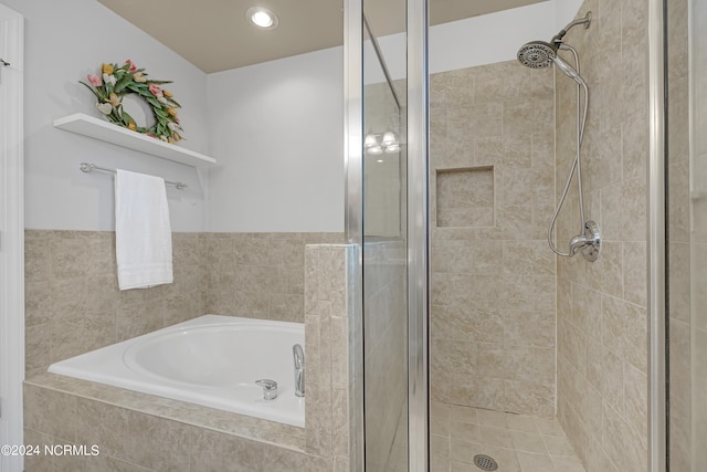 bathroom featuring separate shower and tub