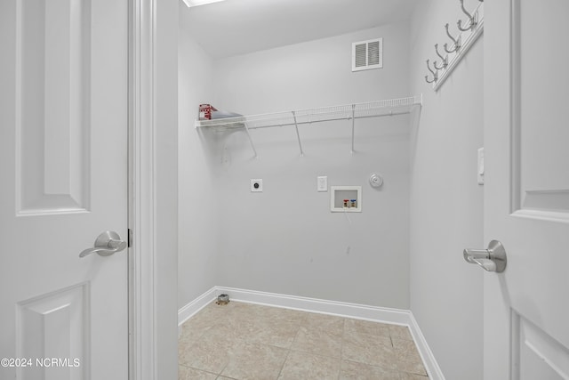 washroom featuring hookup for an electric dryer, light tile patterned flooring, gas dryer hookup, and washer hookup