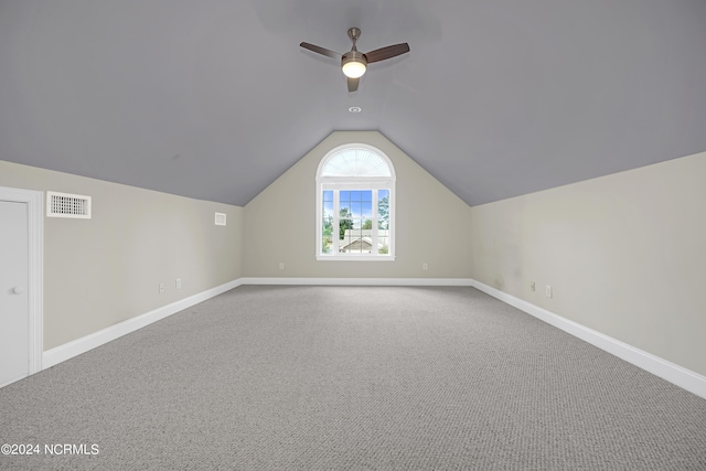 additional living space featuring lofted ceiling, carpet, and ceiling fan