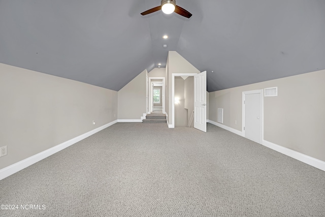 additional living space with lofted ceiling, carpet, and ceiling fan