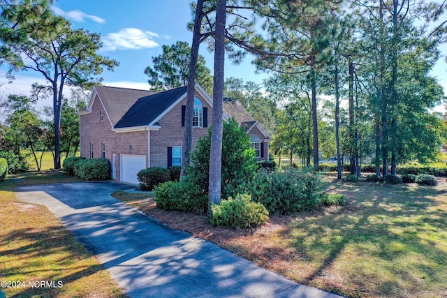 view of home's exterior featuring a yard and a garage