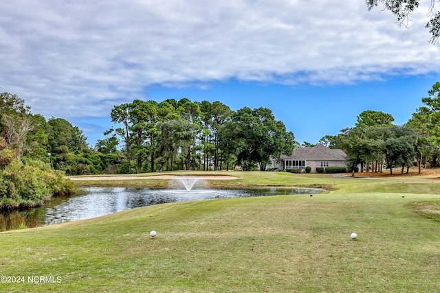 view of community featuring a water view and a lawn