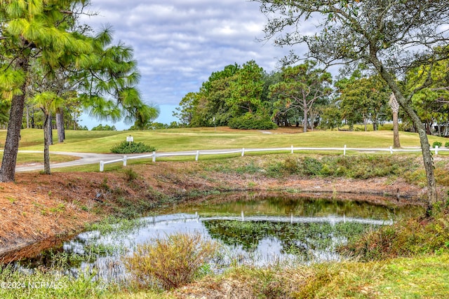 view of community featuring a yard and a water view