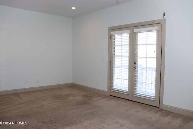 spare room with light carpet