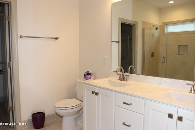 bathroom featuring tile patterned floors, walk in shower, vanity, and toilet