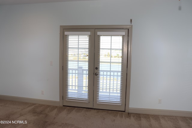 entryway with carpet and french doors